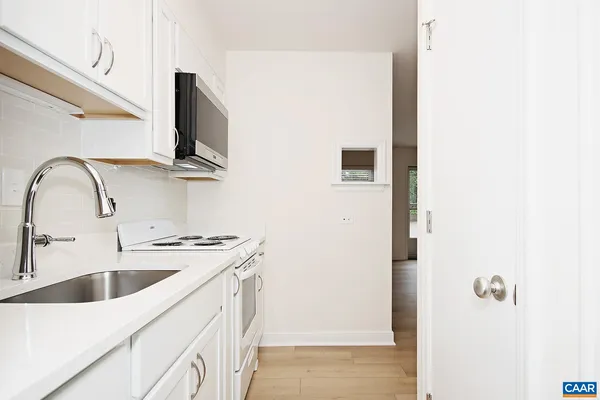 a kitchen with a sink and a refrigerator