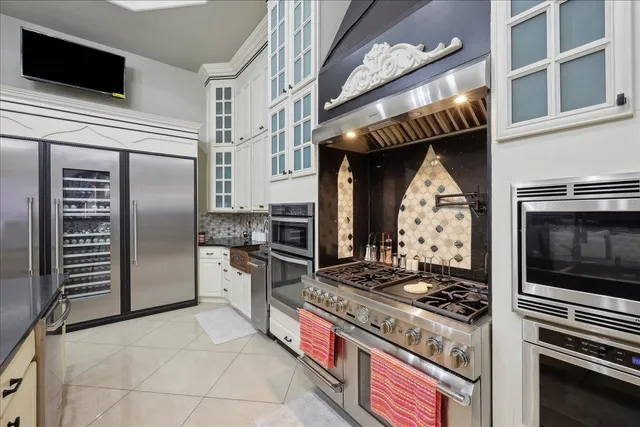a kitchen with stainless steel appliances granite countertop a stove and a refrigerator