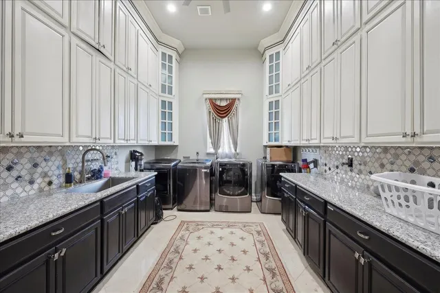 a kitchen with a sink and a stove top oven