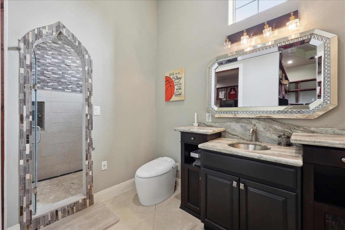12460 Keith Road Beaumont, TX 77713 - Photo 19 of 40 a bathroom with a sink a toilet and shower