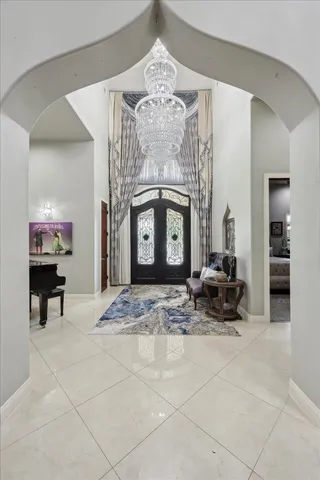 a living room with furniture a fireplace and a chandelier