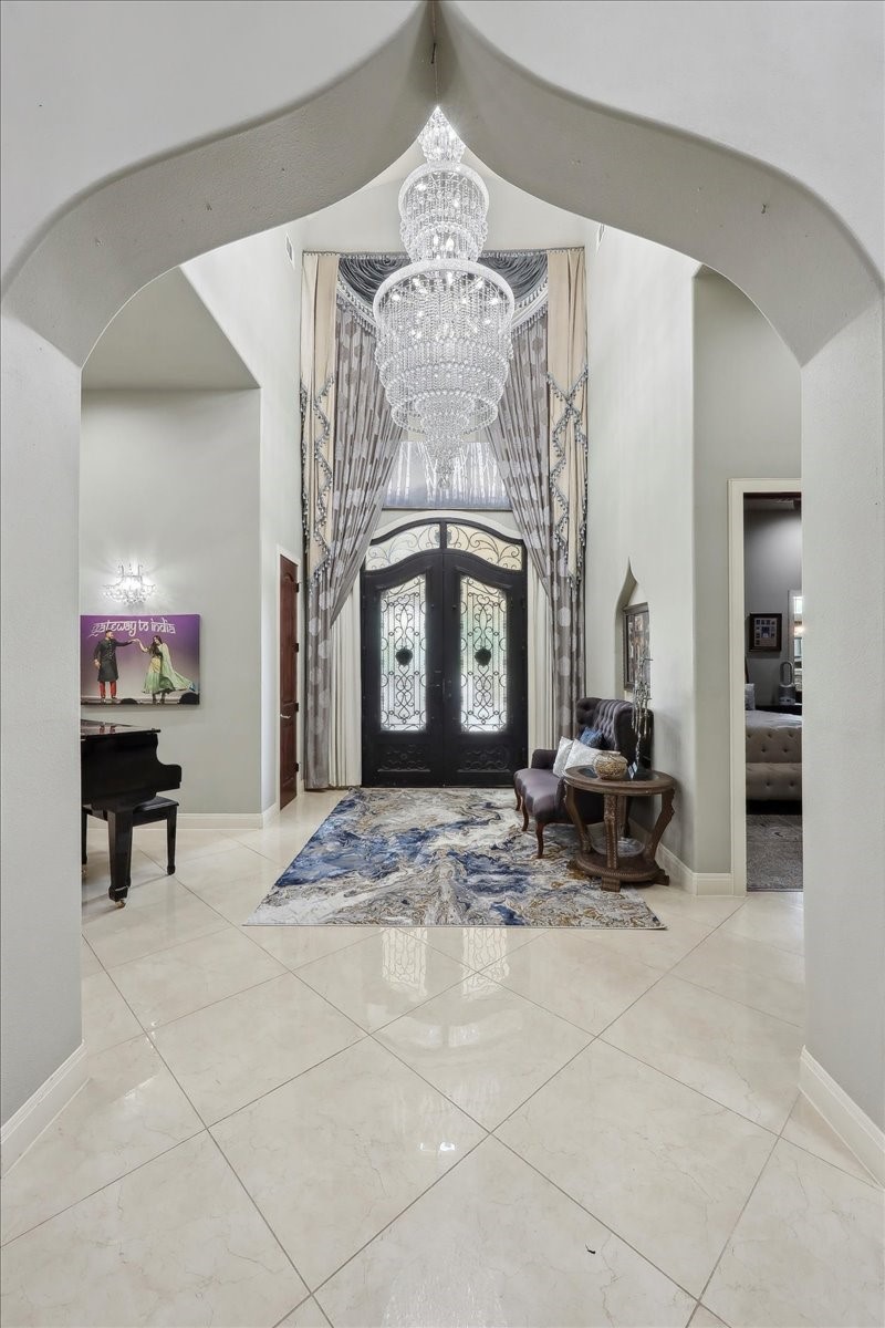 12460 Keith Road Beaumont, TX 77713 - Photo 2 of 40 a living room with furniture a fireplace and a chandelier