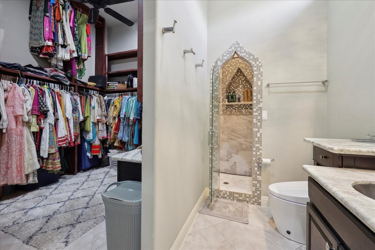 12460 Keith Road Beaumont, TX 77713 - Photo 23 of 40 a view of walk in closet with clothes and shoes