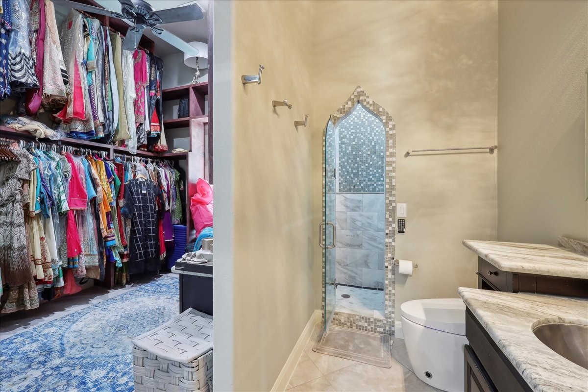 12460 Keith Road Beaumont, TX 77713 - Photo 26 of 40 a view of walk in closet with clothes and shoes