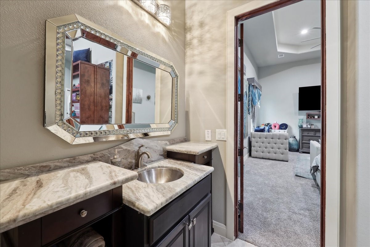 12460 Keith Road Beaumont, TX 77713 - Photo 27 of 40 a en suite bathroom with a sink and a mirror
