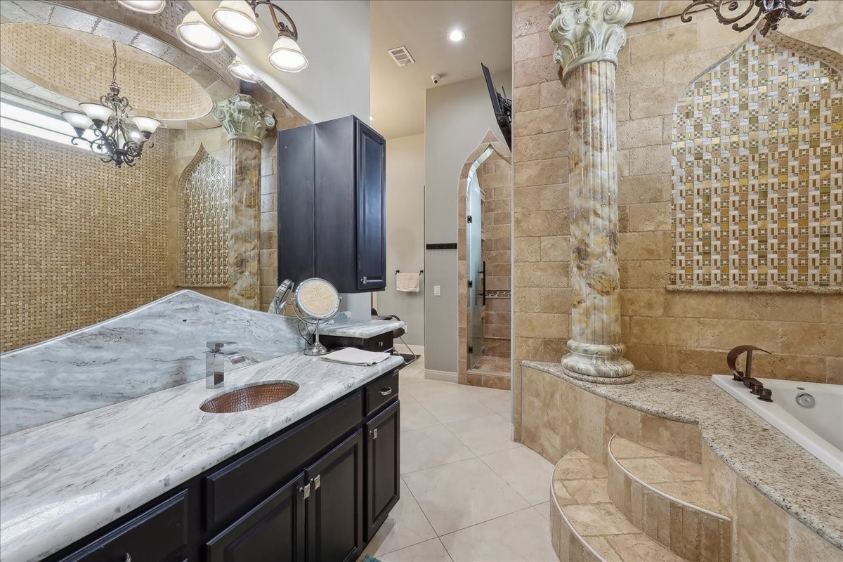 12460 Keith Road Beaumont, TX 77713 - Photo 30 of 40 a spacious bathroom with a granite countertop sink a toilet and shower