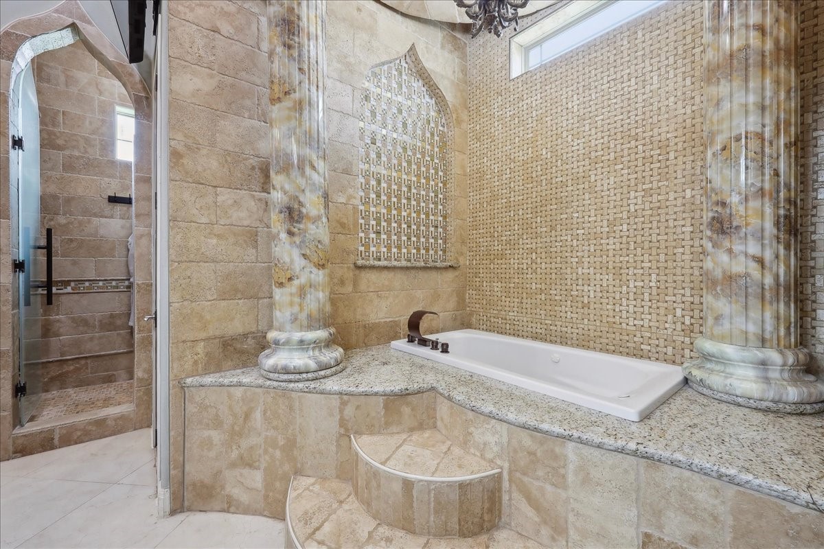 12460 Keith Road Beaumont, TX 77713 - Photo 31 of 40 a bathroom with a granite countertop bathtub and sink