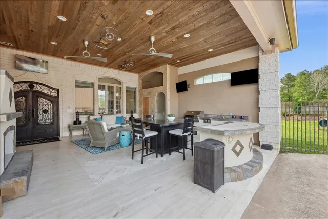 a living room with furniture a flat screen tv and a stove
