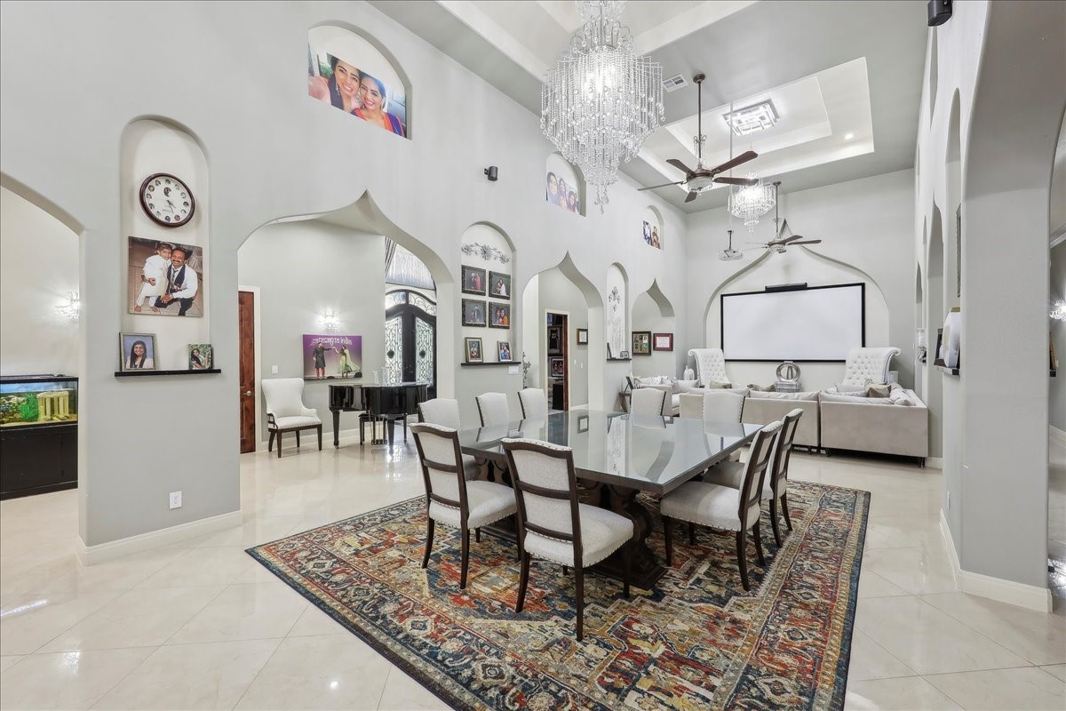 12460 Keith Road Beaumont, TX 77713 - Photo 8 of 40 a dining room with wooden floor and a chandelier
