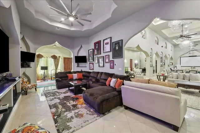 a living room with furniture fireplace and a large window