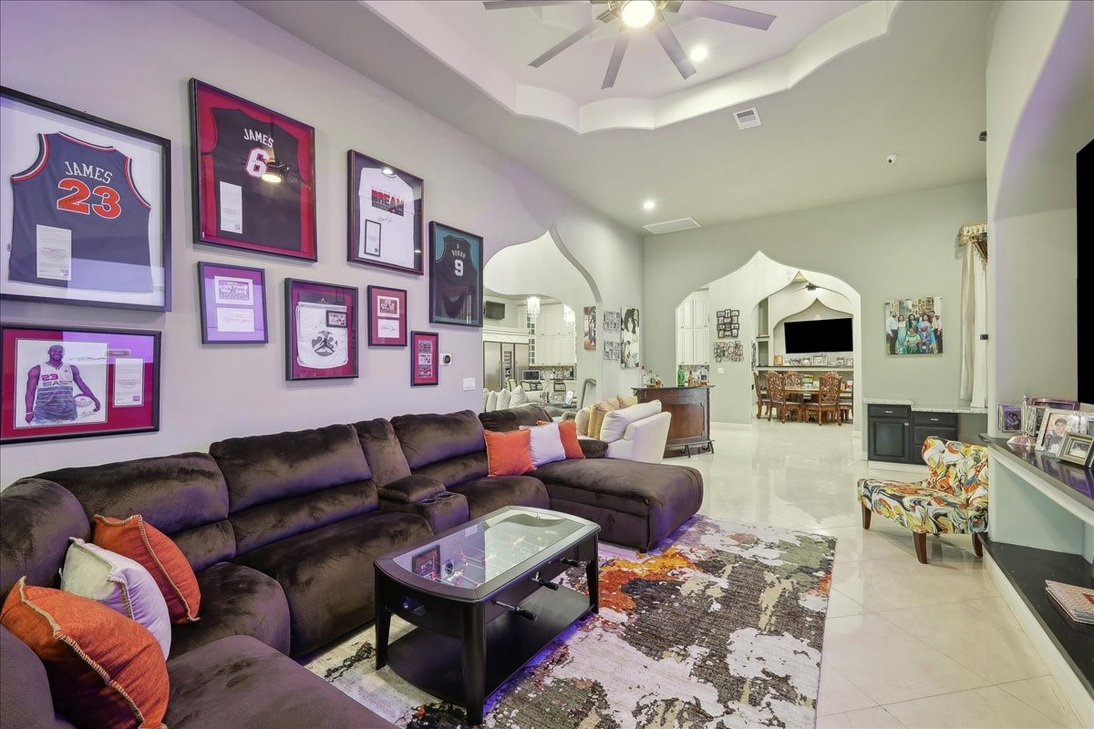 12460 Keith Road Beaumont, TX 77713 - Photo 10 of 40 a living room with furniture a flat screen tv and a chandelier