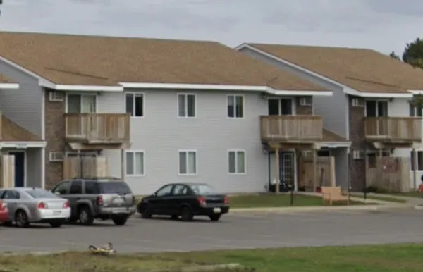 a car parked in front of a white house