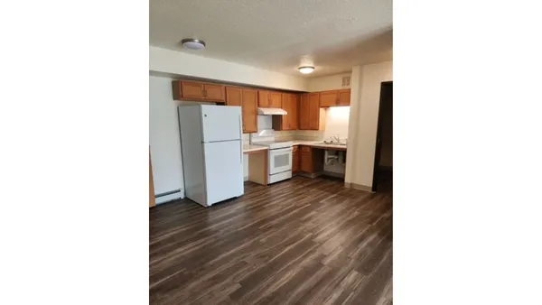 a kitchen with a refrigerator and a sink