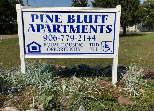 a sign broad in front of a brick building