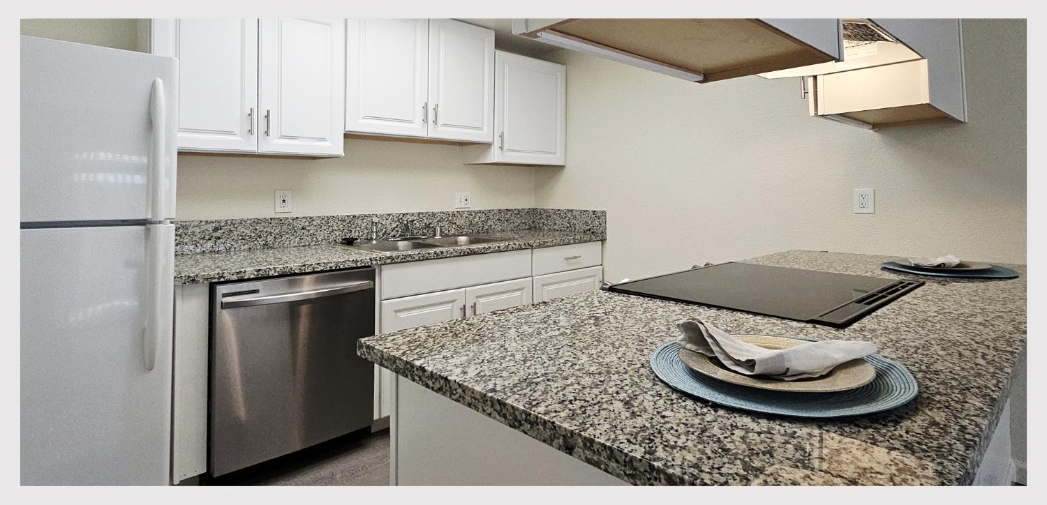 5130 Rescue Court Sacramento, CA 95841 - Photo 11 of 47 a kitchen with a sink and a stove with white countertops