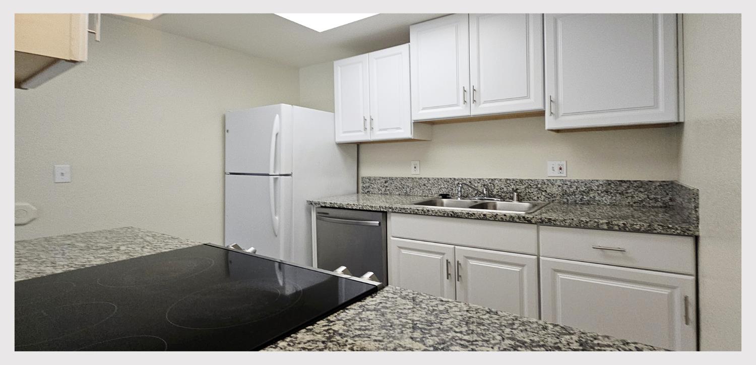 5130 Rescue Court Sacramento, CA 95841 - Photo 14 of 47 a kitchen with granite countertop a sink cabinets and stainless steel appliances