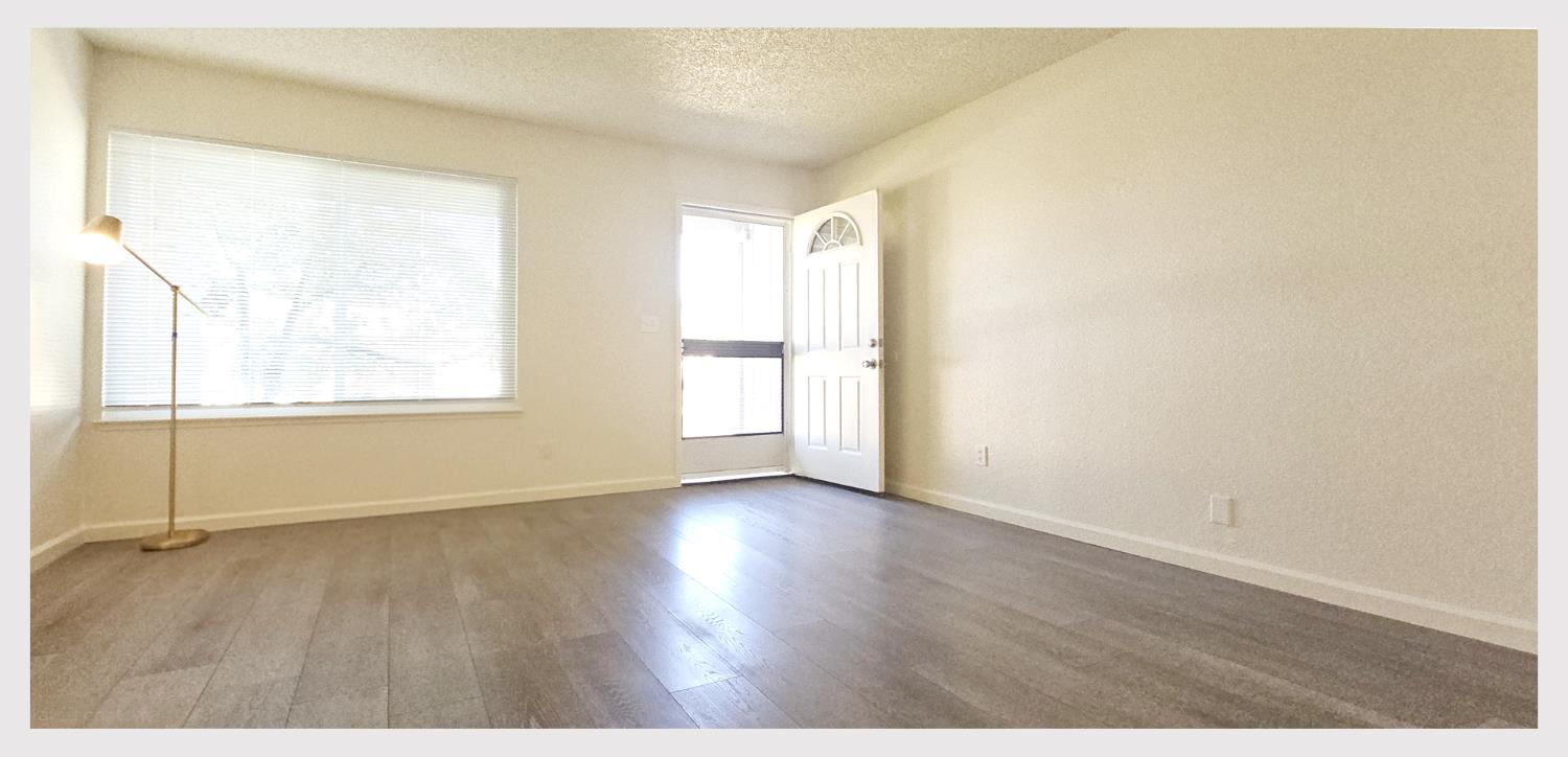 5130 Rescue Court Sacramento, CA 95841 - Photo 6 of 47 a view of an empty room with wooden floor and a window