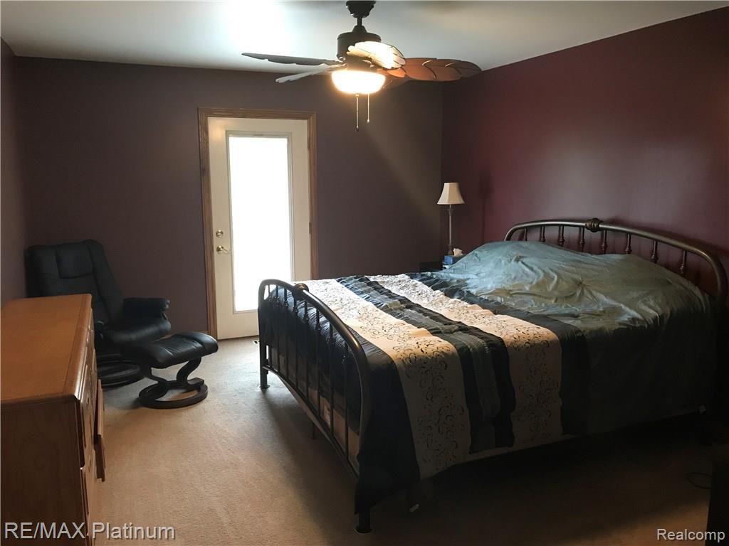 198 West Coon Lake Road Howell, MI 48843 - Photo 8 of 22 Large master bedroom with private bath, walk-in closet and direct access to deck.