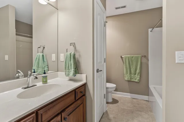 a bedroom with a bed and dresser