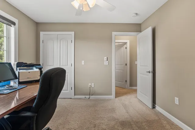 a bed room with a bed and a ceiling fan