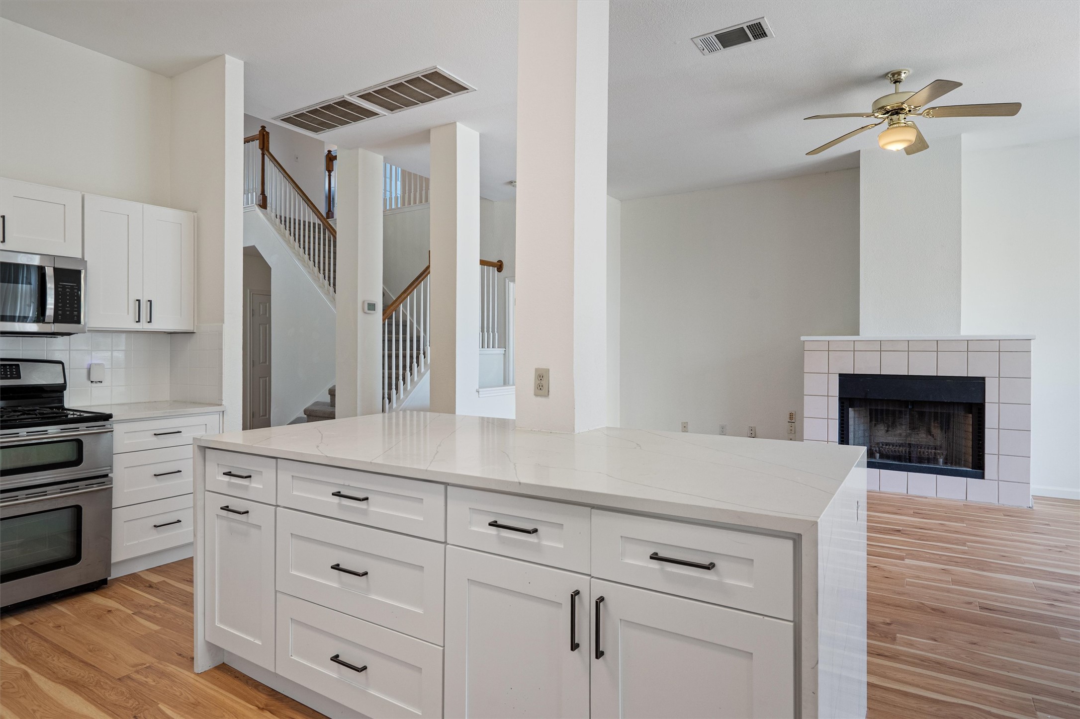 100 Parque Circle Georgetown, TX 78626 - Photo 17 of 39 a kitchen with white cabinets and a fireplace