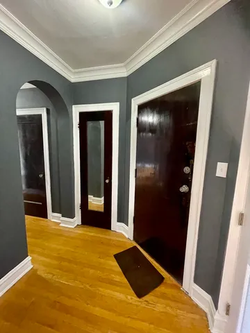 a view of an empty room with closet and mirror