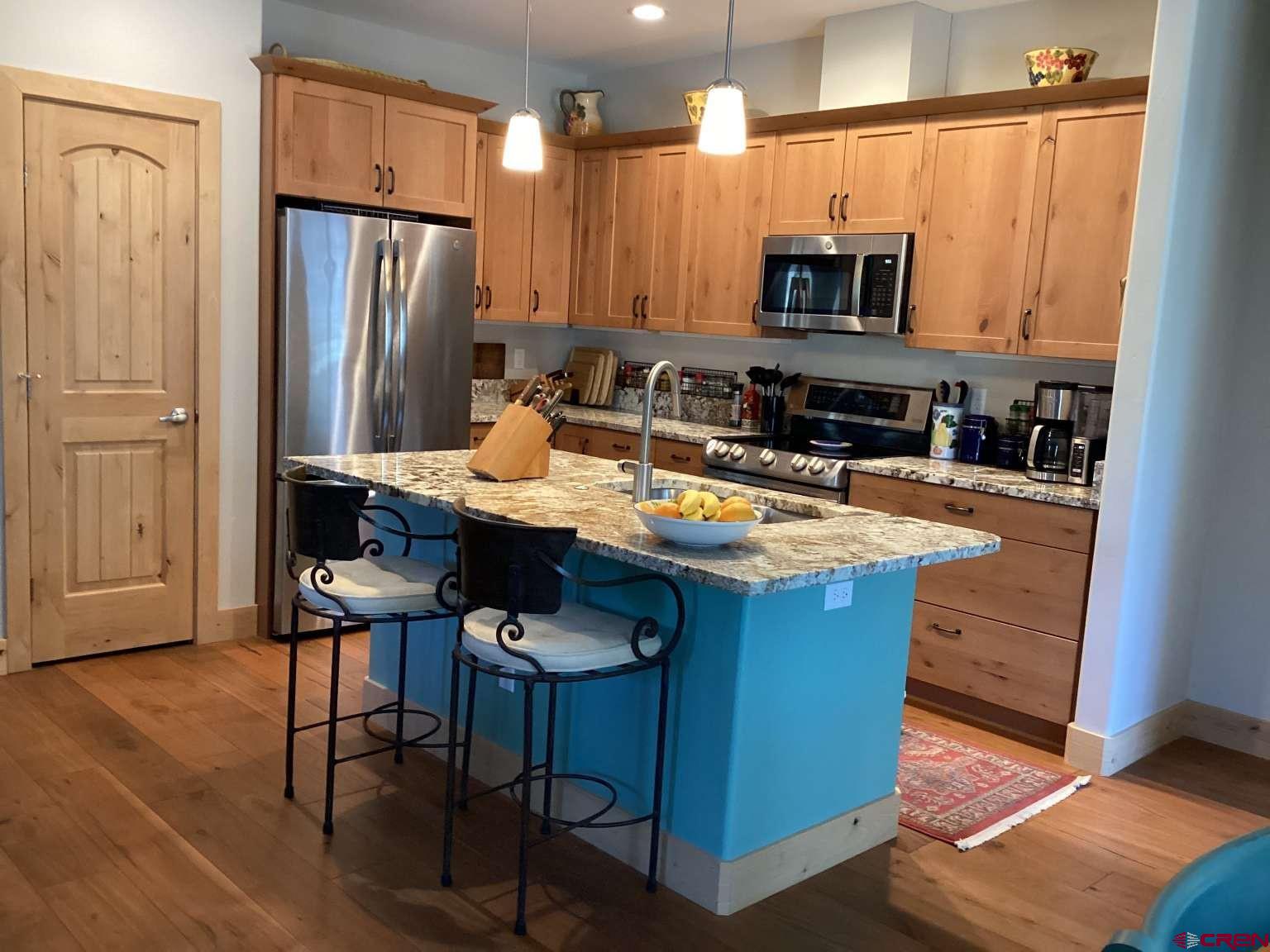 416 West 28th Street Durango, CO 81301 - Photo 3 of 16 a kitchen with stainless steel appliances a table chairs microwave and refrigerator