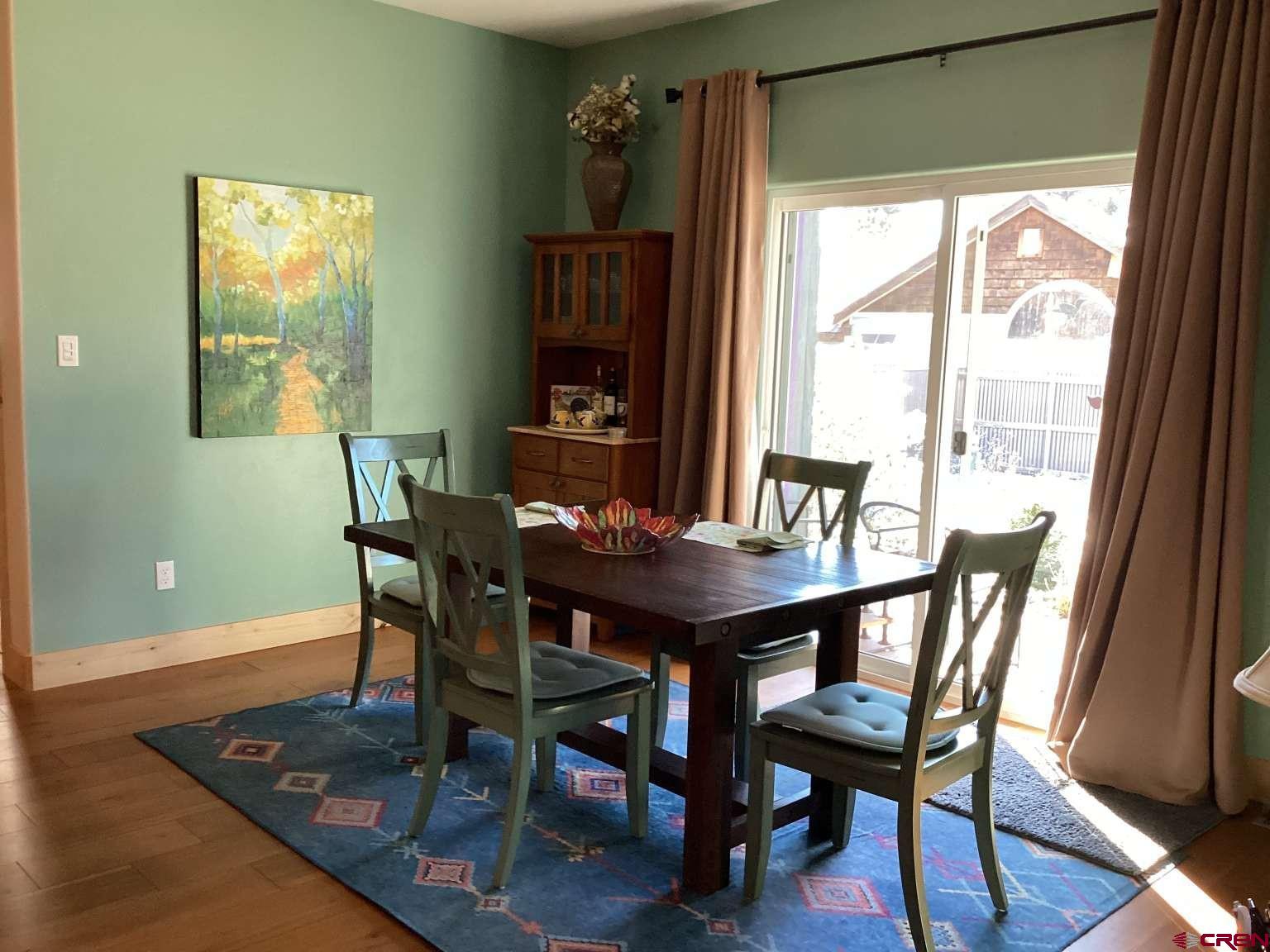 416 West 28th Street Durango, CO 81301 - Photo 4 of 16 a view of a dining room with furniture window and wooden floor