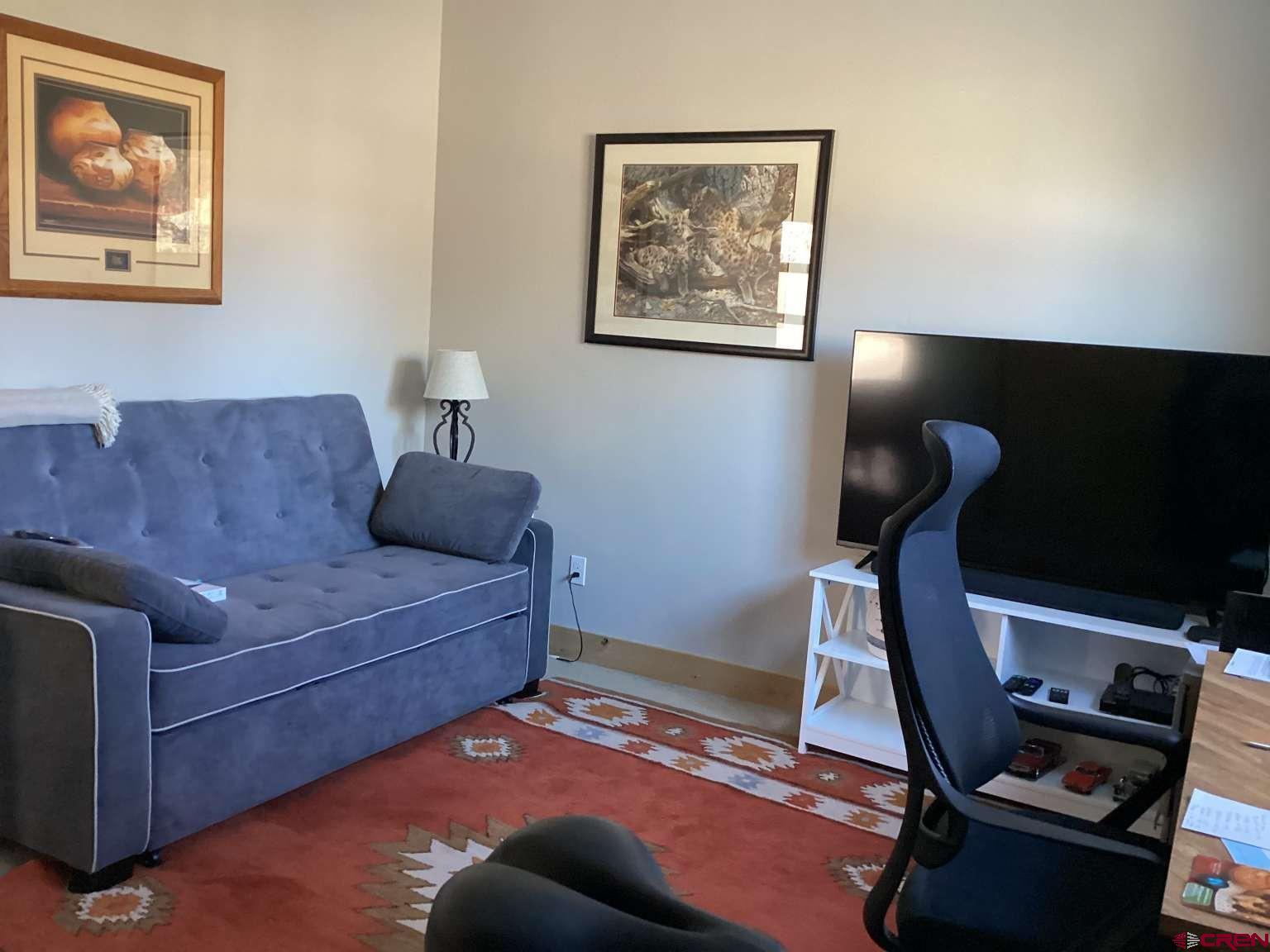 416 West 28th Street Durango, CO 81301 - Photo 8 of 16 a living room with furniture and a flat screen tv