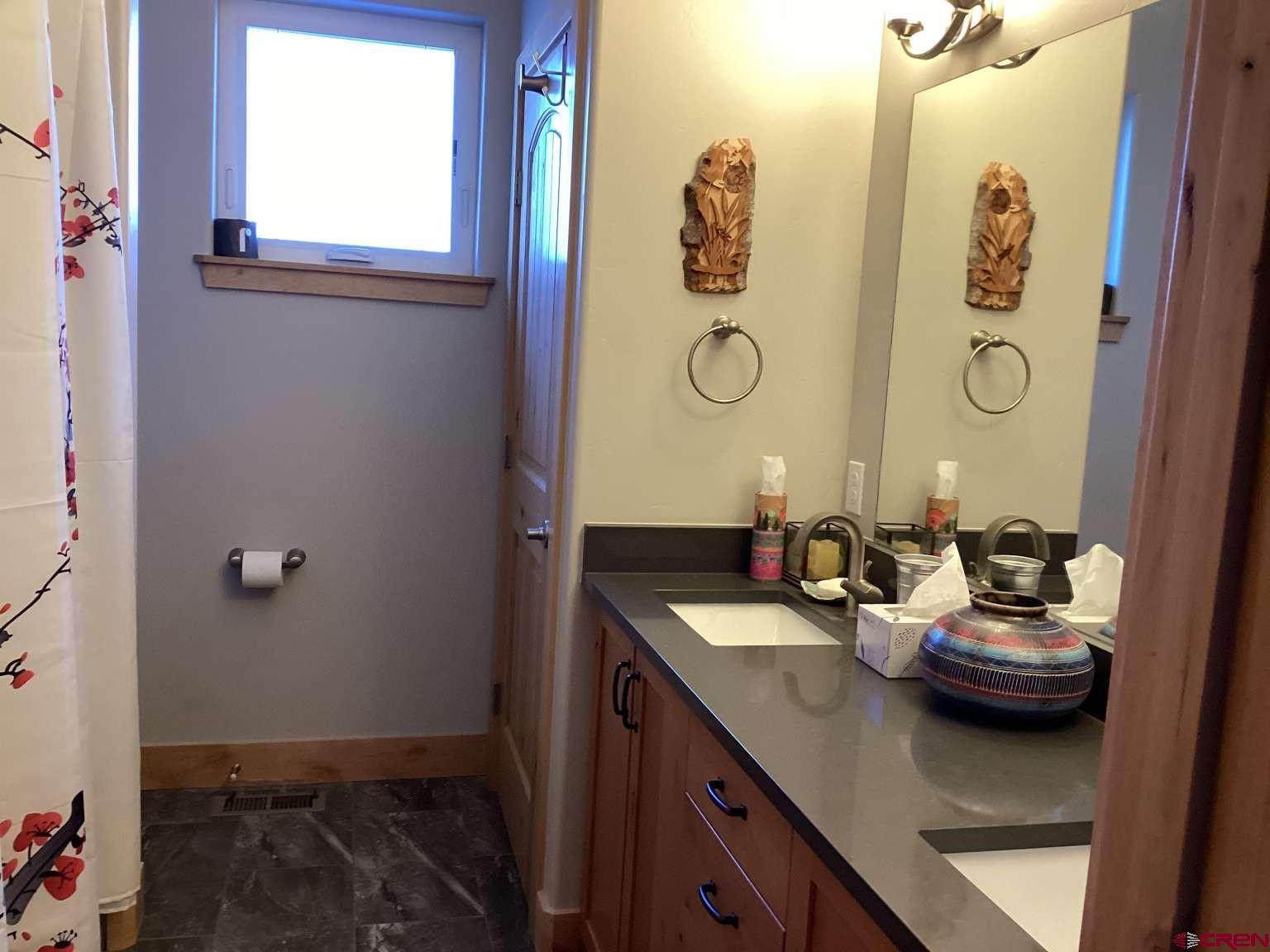416 West 28th Street Durango, CO 81301 - Photo 9 of 16 a bathroom with a sink and a mirror