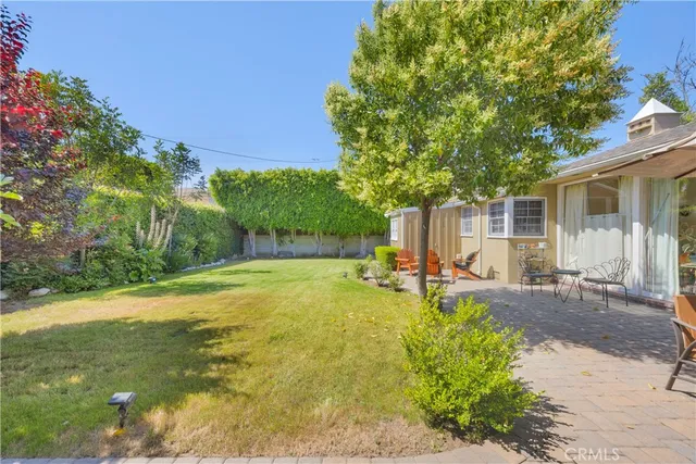 a house with huge green field in front of it