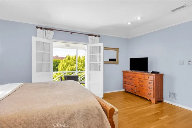 a bedroom with a bed and a television