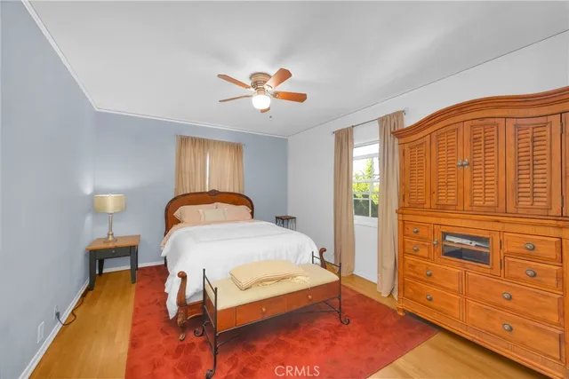 a bedroom with a bed and a ceiling fan