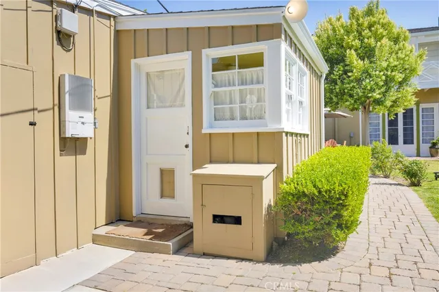 a front view of a house with a garden and plants