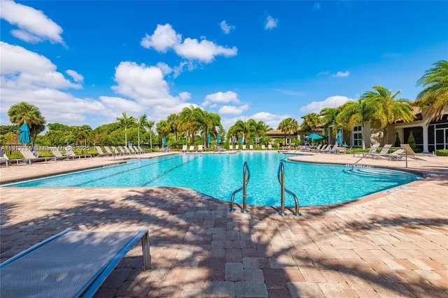 a view of a swimming pool with an outdoor space and seating area