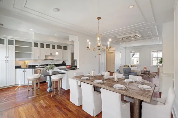 a kitchen with a sink stove and wooden floor