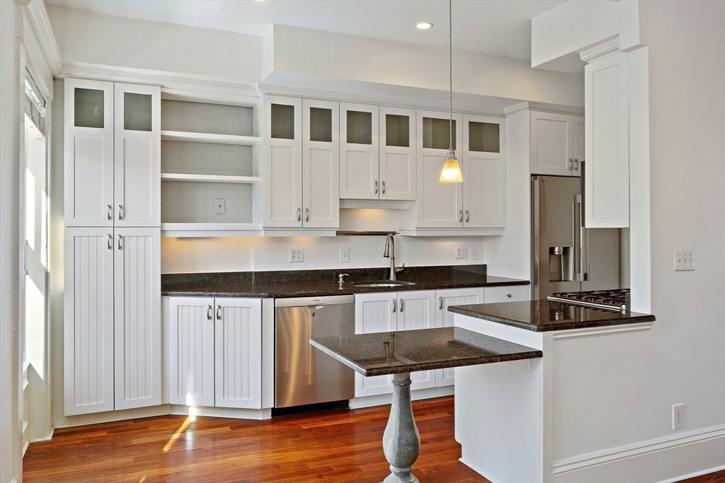 65 Rutland Street, Unit 3 Boston, MA 02118 - Photo 13 of 25 a kitchen with stainless steel appliances granite countertop a stove and a refrigerator
