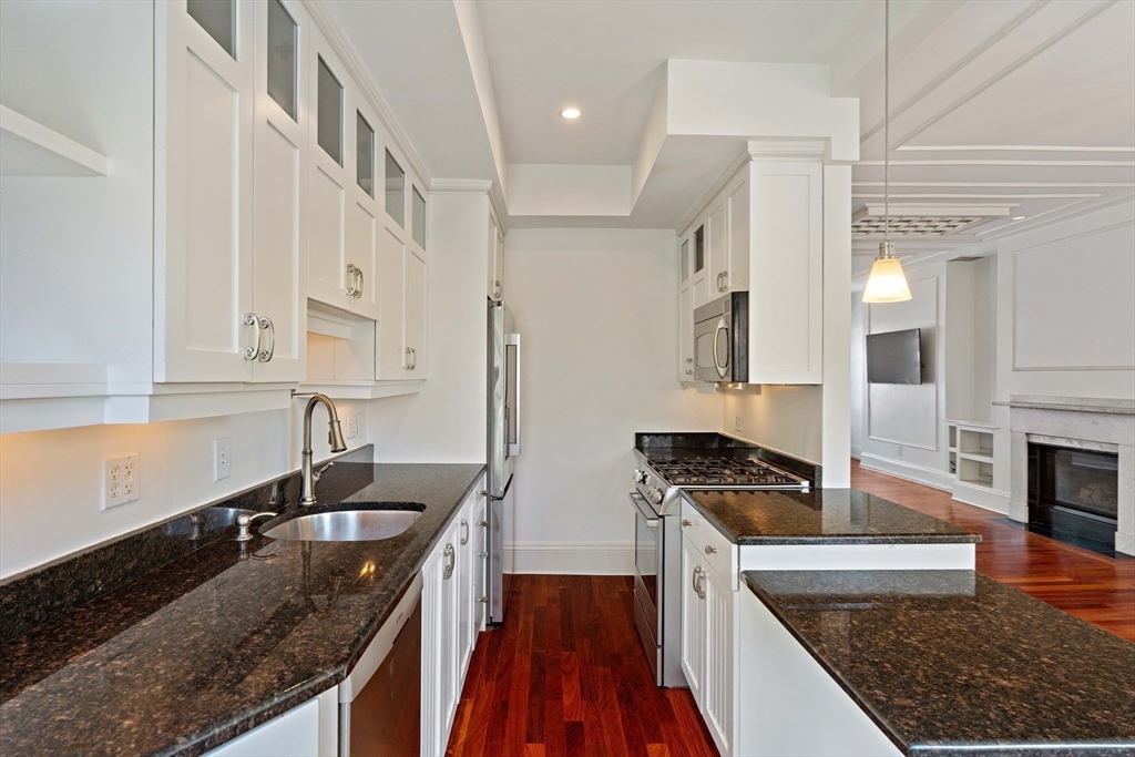65 Rutland Street, Unit 3 Boston, MA 02118 - Photo 14 of 25 a kitchen with stainless steel appliances granite countertop a sink stove and refrigerator