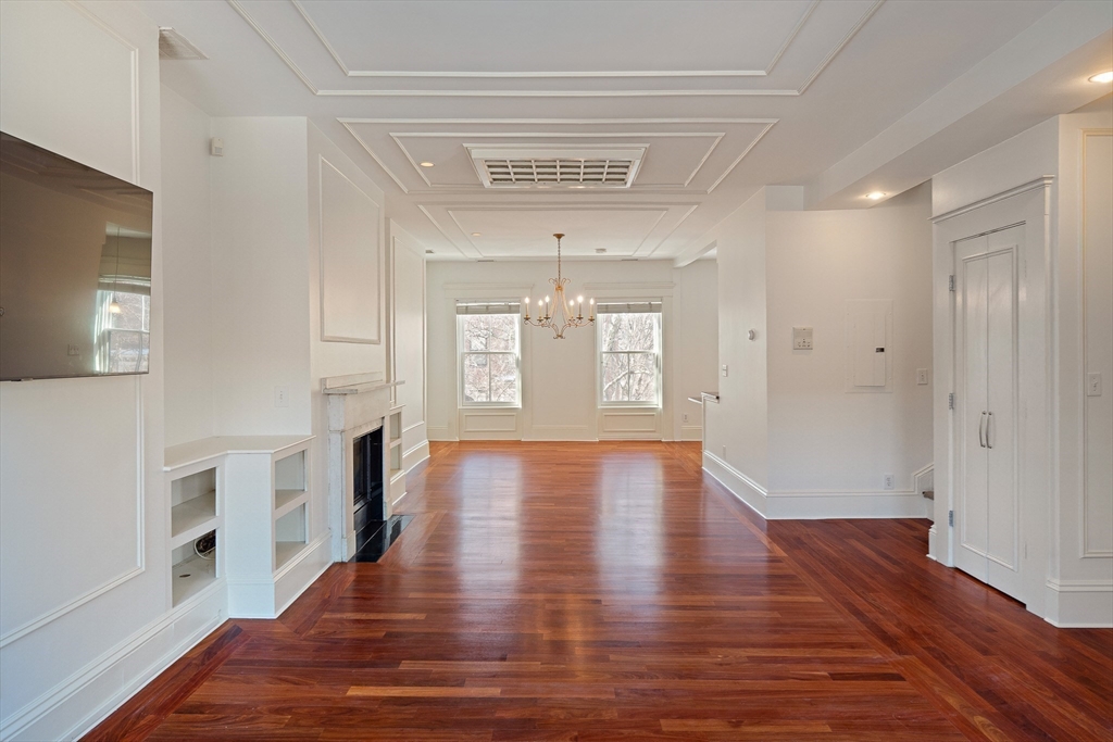 65 Rutland Street, Unit 3 Boston, MA 02118 - Photo 19 of 25 a view of an empty room with a window and wooden floor