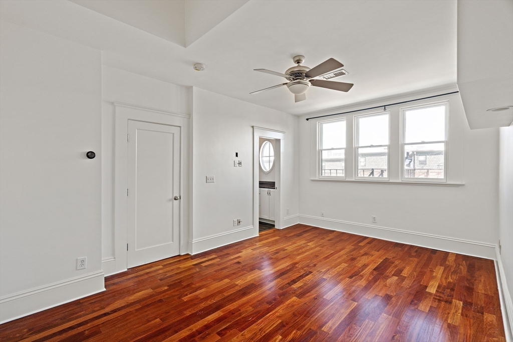 65 Rutland Street, Unit 3 Boston, MA 02118 - Photo 20 of 25 a view of empty room with wooden floor and fan