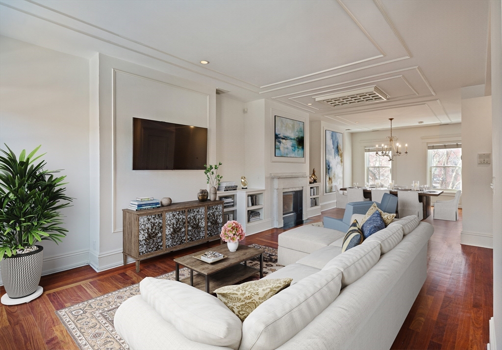 65 Rutland Street, Unit 3 Boston, MA 02118 - Photo 2 of 25 a living room with furniture a fireplace and a flat screen tv