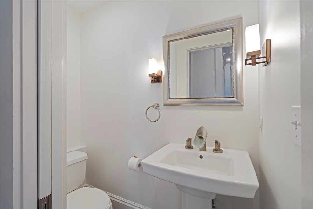 65 Rutland Street, Unit 3 Boston, MA 02118 - Photo 4 of 25 a bathroom with a toilet sink and mirror