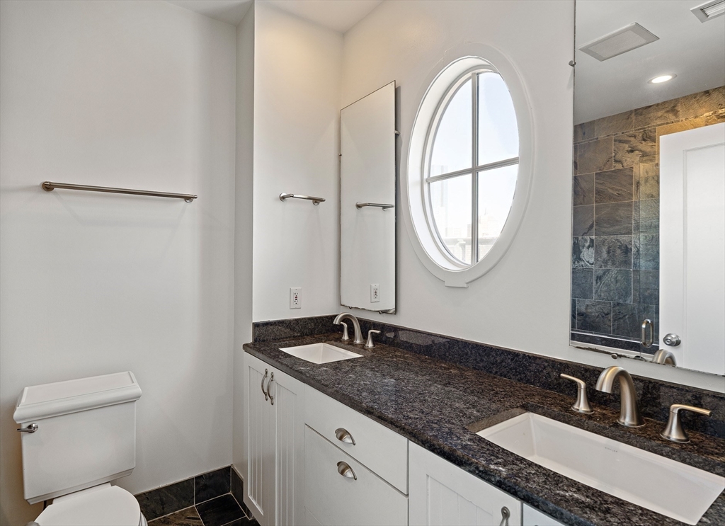 65 Rutland Street, Unit 3 Boston, MA 02118 - Photo 6 of 25 a bathroom with a granite countertop sink a toilet and a mirror