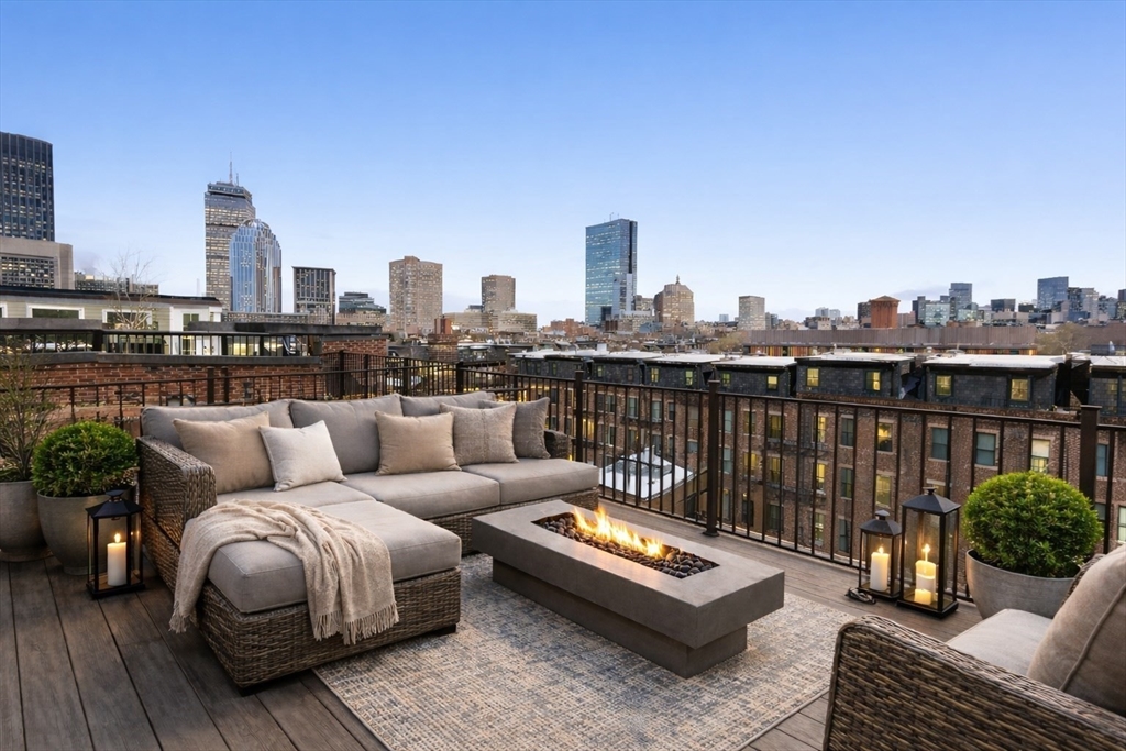 65 Rutland Street, Unit 3 Boston, MA 02118 - Photo 9 of 25 a roof deck with couch and a potted plant
