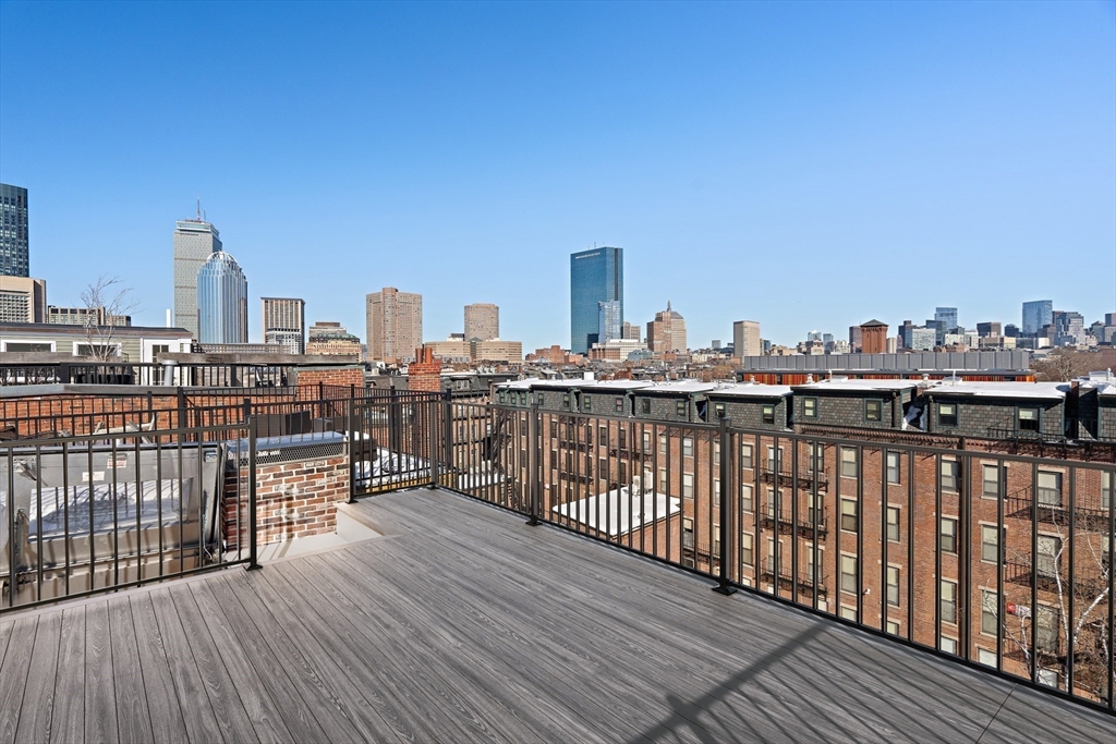 65 Rutland Street, Unit 3 Boston, MA 02118 - Photo 10 of 25 a view of roof deck with two chairs and wooden floor