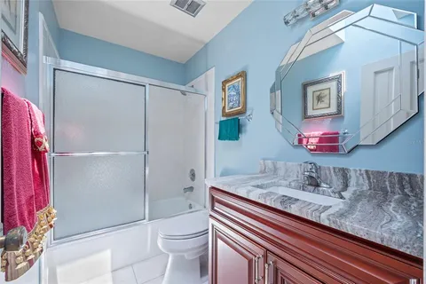 an aerial view of a house with a garden and lake view