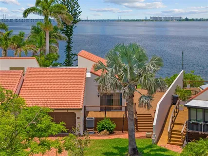 a view of a tennis ground with palm trees