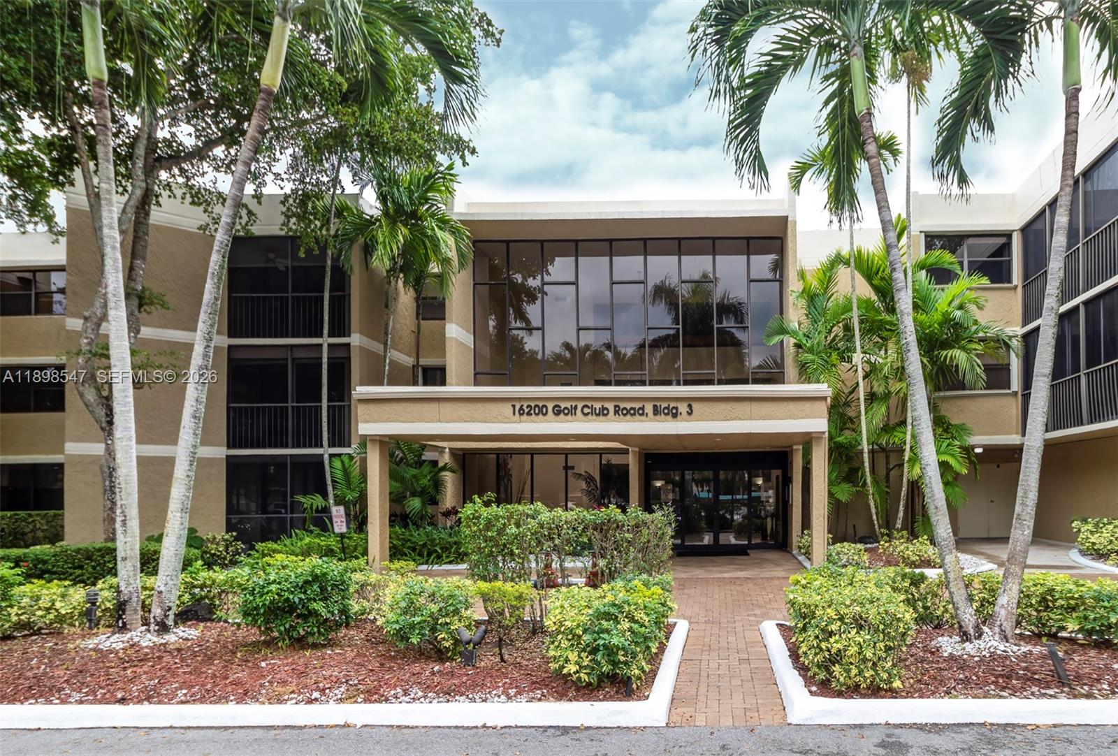 16200 Golf Club Road, Unit 312 Weston, FL 33326 - Photo 1 of 31 a front view of a house with garden