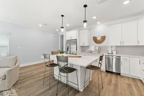 a large kitchen with a table and chairs