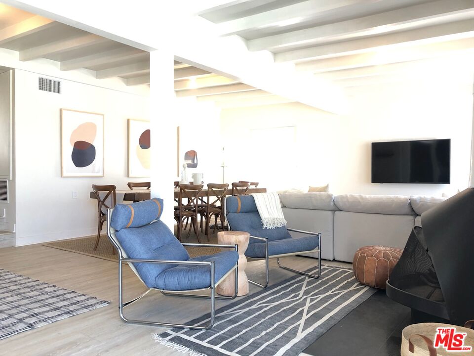 7133 Birdview Avenue Malibu, CA 90265 - Photo 3 of 9 a living room with furniture and a flat screen tv